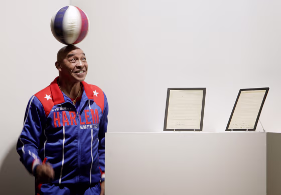 Image: Former Harlem Globetrotter Curly Neal spins a ball on his head at Sotheby's in New York in 2010.
