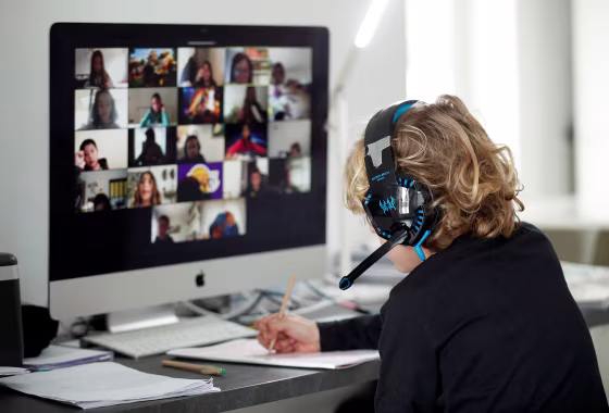 Image: A student takes classes online with his companions using the Zoom APP at home
