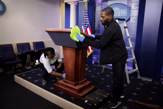 Image: Workers clean the podium before a coronavirus task force briefing at the White House on April 1, 2020.