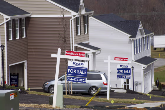 Model homes and for sale signs line the streets in Zelienople, Pa., on March 18, 2020.
