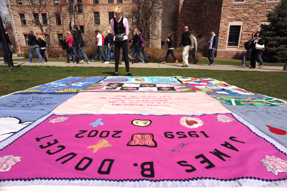 (HR) Gert McMullin looks at some of the quilts that are on display on the green grass outside of Norlin Library on the University of Colorado campus in Boulder. She was one out of the two first volunteers that started the AIDS Memorail Quilt project in Sa