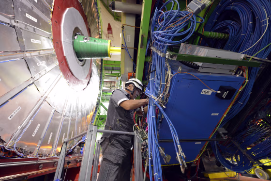 Image: A technician works on the CMS detector, part of the CERN LHC experiment