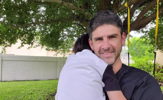 Dr. Christian Assad hugs his five-year-old, Kian. Assad is a cardiologist, not an emergency room physician, but when Kian fell and split his head open, Assad relied on his medical background to treat Kian at home instead of risking exposing his family to the coronavirus in a hospital.