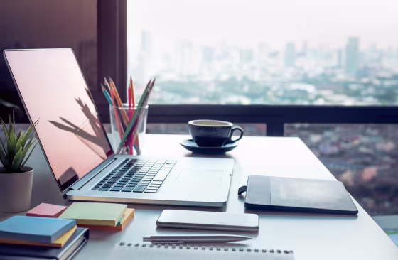 Modern work table with computer laptop and cityscapes view from window.Business concepts ideas