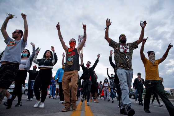 A crowd marches through downtown Des Moines following a night of protesting in support of George Floyd on Saturday, May 30, 2020.