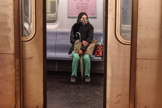 A passenger wears a mask while riding on a New York City subway train on May 6, 2020.