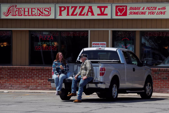 Image: Jim and Marilyn Ridel eat their take out lunch in the parking lot outside the restaurant amid the coronavirus disease (COVID-19) outbreak in Keene, New Hampshire