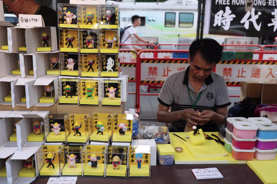 Image: A vendor crafts statues of Hong Kong protesters at a rally marking the one-year anniversary of the start of the protests in Hong Kong, at Liberty Square in Taipei