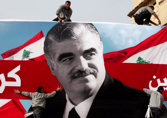 Image: FILE PHOTO: Workers prepare a giant poster depicting Lebanon's assassinated former prime minister Rafik al-Hariri, in downtown Beirut