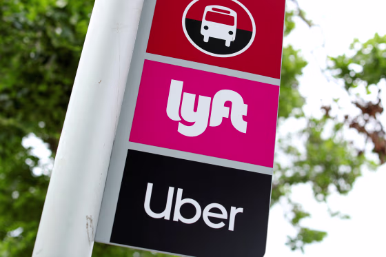 Image: A sign marks a rendezvous location for Lyft and Uber users at San Diego State University in San Diego