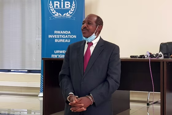 Image: Rusesabagina is detained and paraded in front of media in handcuffs in Kigali