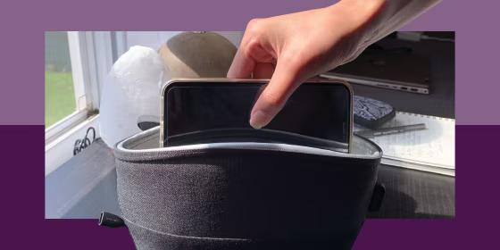 hand putting smartphone in uv light sanitizing bag
