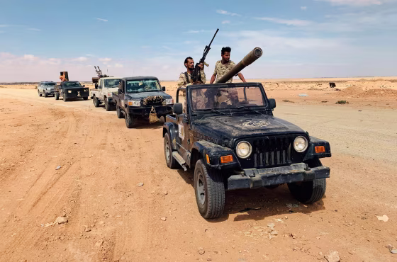 Image: Troops loyal to Libya's internationally recognized government patrol the area in Zamzam, near Abu Qareen