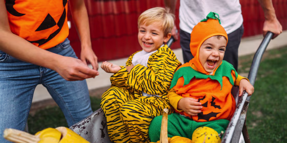 children having fun outside in halloween costumes