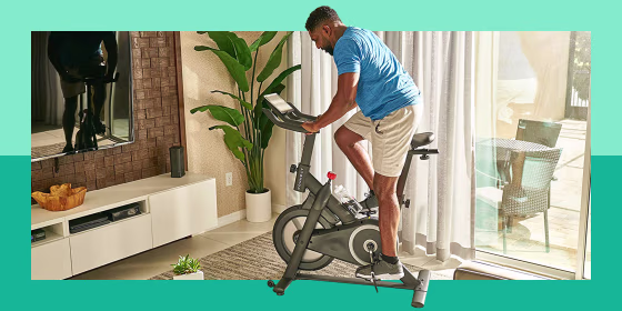 man using exercise bike in living room