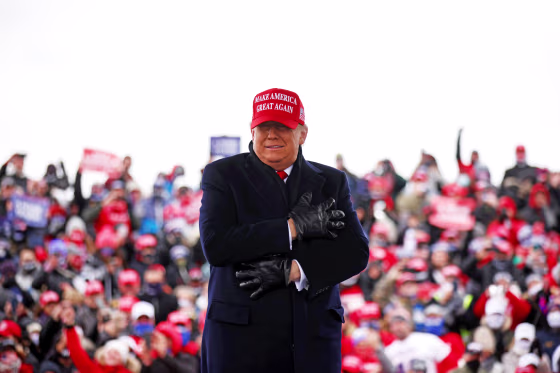 Image: U.S. President Donald Trump reacts to cold weather and wind during a campaign rally at Michigan Sports Stars Park in Washington