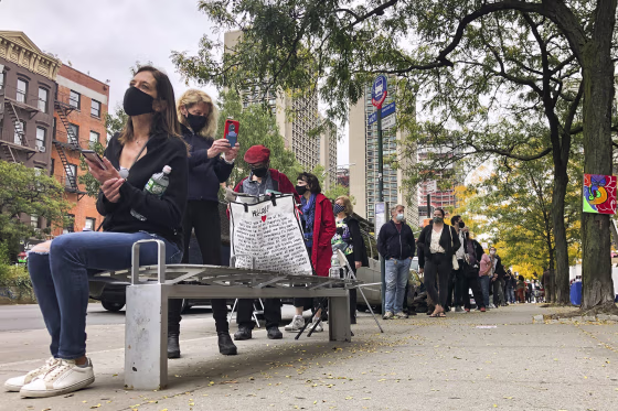 Image: Voters wait in line for a Houston Street polling site on the first day of early voting, Saturday, Oct. 24, 2020, in New York.
