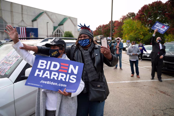 Supporters cheer as Joe Biden speaks during a \"Souls to the Polls\" event at Sharon Baptist Church in Philadelphia on Nov. 1, 2020.