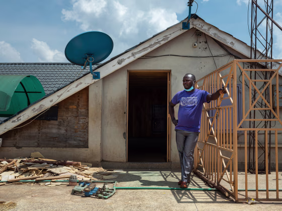 Image: Former Uber driver Harrison Munala on the rooftop of his former apartment building, where his wife and their three children were evicted from in mid-August after falling behind on their rent, in Nairobi's Kwangware neighborhood, Kenya