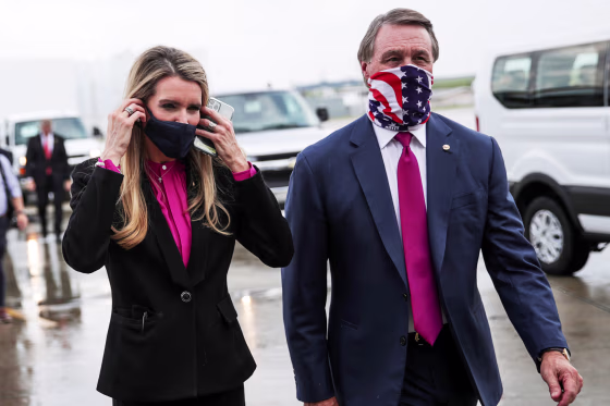 Image: FILE PHOTO: Republican U.S. Senators from Georgia Loeffler and Perdue walk together at Hartsfield-Jackson Atlanta International Airport in Atlanta, Georgia