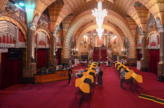Image: People cast their ballot at the Pantages Theatre in Hollywood