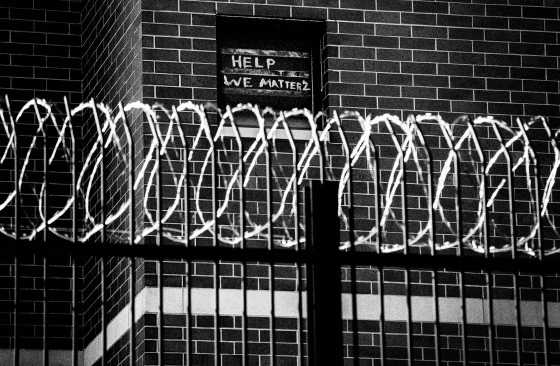 Signs made by prisoners pleading for help are seen on a window of Cook County Jail in Chicago
