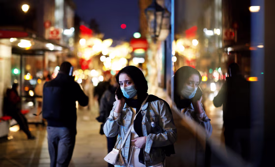 Image: Pedestrians walk past shops on Piccadilly on Dec. 19, 2020, in London.
