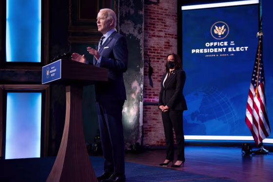 Vice President-elect Kamala Harris listens while as President-elect Joe Biden speaks at the Queen Theater on Dec. 28, 2020, in Wilmington, Del.