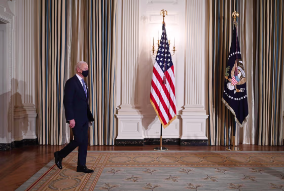 President Joe Biden arrives to swears in presidential appointees during a virtual ceremony in the Oval Office of the White House on Jan. 20, 2021.
