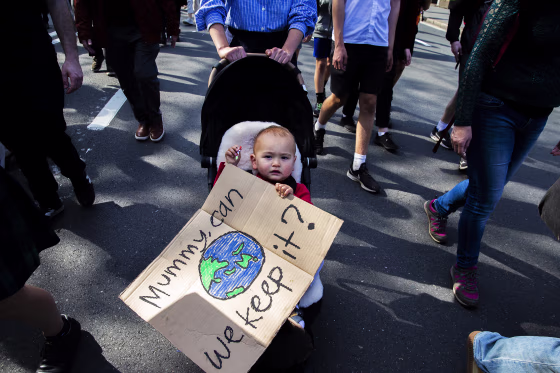 Image: Thousands of school students and protesters march along College Street during a climate strike rally in Sydney