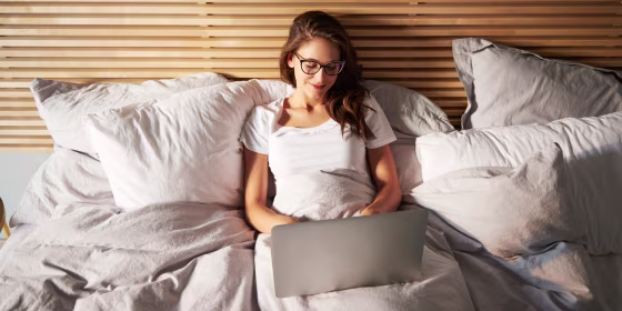 Woman snuggled under her comforter