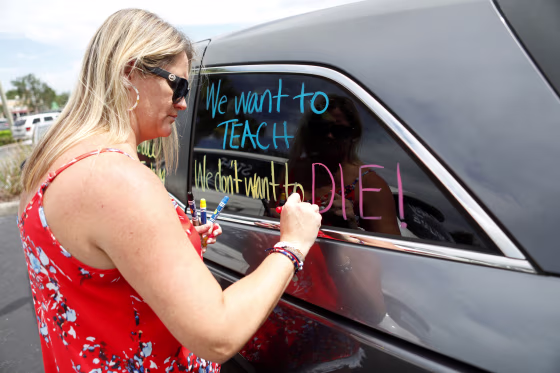 Florida teachers hold a protest in front of the Pasco County School district office