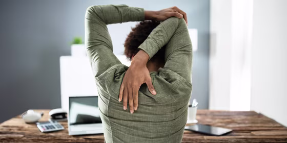 Rear View Of A Businessman Stretching His Arms