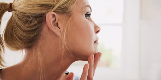 Woman touching her face after using a face razor