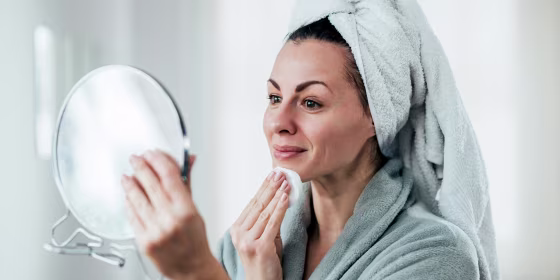 Older woman performing her skin care routine