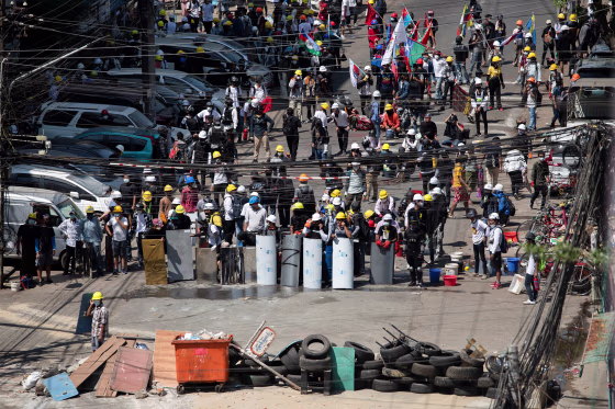 Image: Demonstrators block a road during an anti-coup protest in Yangon, Myanmar,