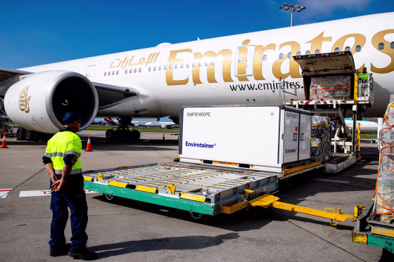Image: Container RAP81400PC holding the AstraZeneca COVID-19 vaccine is removed from the Emirates airlines plane as the first vaccination doses into the country arrives at Sydney International airport