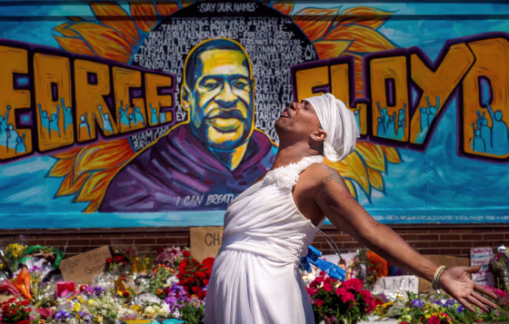 Image: A woman reacts at a memorial for George Floyd following a day of demonstration in a call for justice in Minneapolis