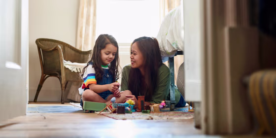 Mother and daughter playing with toys