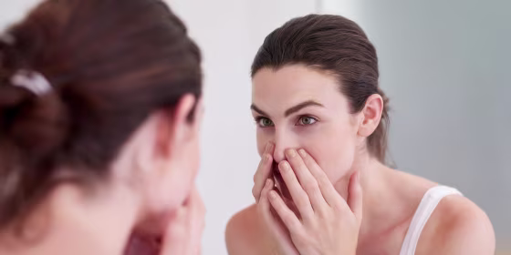Woman looking at her pores on her nose