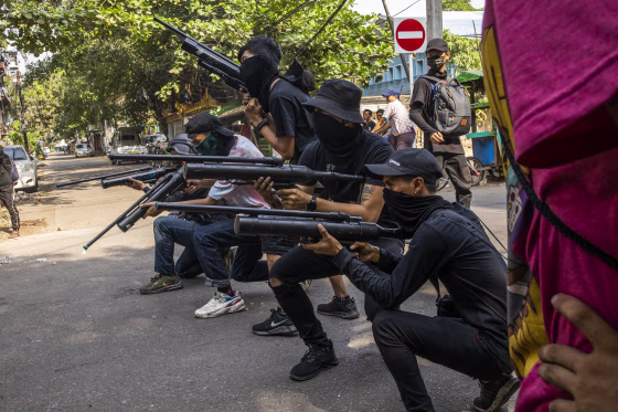 Anti-coup protesters line in formation with homemade air rifles during a demonstration against the military coup in Yangon, Myanmar, Saturday, April 3, 2021.