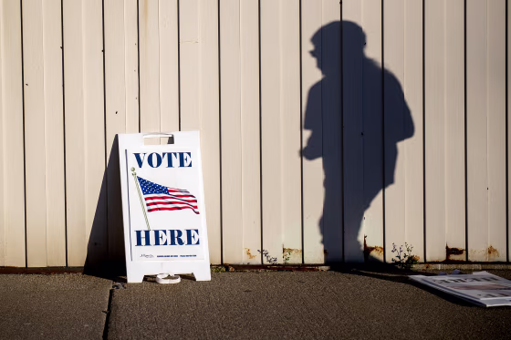 Image: A voter walks toward the entrance of the Boys and Girls Clubs of the Great Lakes Bay Region to cast their ballot in Bay City, Mich., during Election Day on Nov. 3, 2020.