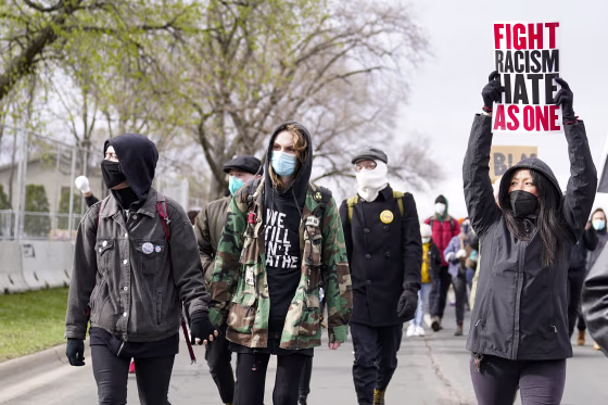 Image: Demonstrators march outside the Brooklyn Center Police Department to protest the shooting death of Daunte Wright on April 13, 2021, in Brooklyn Center, Minn.
