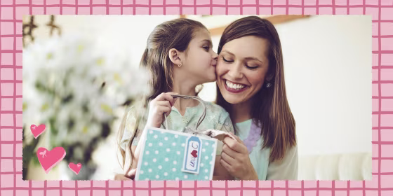 Daughter kissing her mother as she gives her a gift for Mother's Day