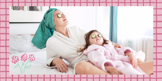 Mother and young daughter cleaning back on bed, wearing robes, towels on their heads and using cucumbers over their eyes
