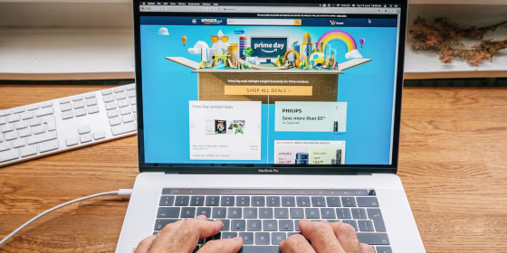 Hands typing on computer with Prime Day up on the screen