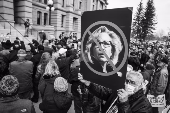 Image: A man holds up a sign against Rep. Liz Cheney, R-Wyo., as Rep. Matt Gaetz, R-Fla., speaks to a crowd during a rally against her on Jan. 28, 2021 in Cheyenne, Wyo.