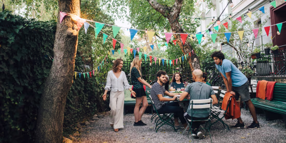 Group of friends hanging outside, in a small patio/garden