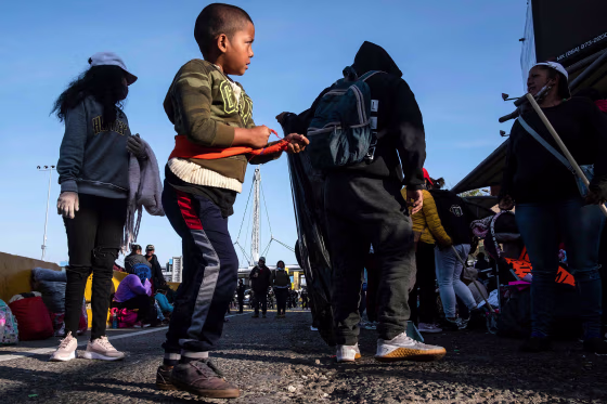Image: Migrants and asylum seekers are seen after spending the night in one of the car lanes off the San Ysidro Crossing Port on the Mexican side of the US-Mexico border in Tijuana on April 24, 2021.