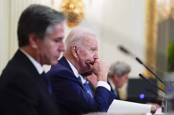President Joe Biden attends a meeting with South Korean President Moon Jae-in alongside Secretary of State Antony Blinken, left, in the State Dinning Room of the White House on May 21, 2021.